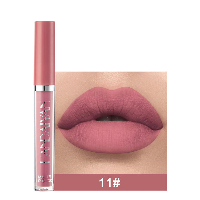 Lip gloss with a pink shade on a white background