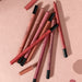 Set of Derolde lip pencils on a pink background